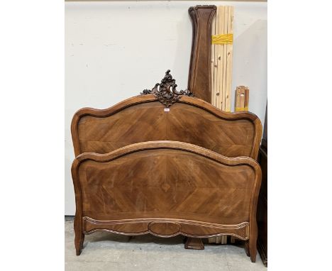 A 4'6" French walnut bedstead with shell carved headboard