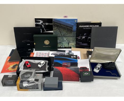 A collection of press release and other automative printed matter and models, various marques including MG; Kia; Citroen; Lan