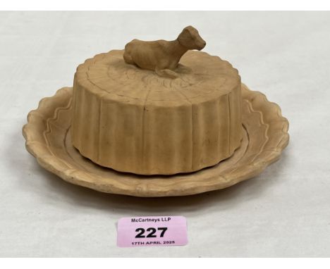 A 19th century French biscuit porcelain butter dish or beurrier Breton, the cover with recumbent cow finial 7" diam