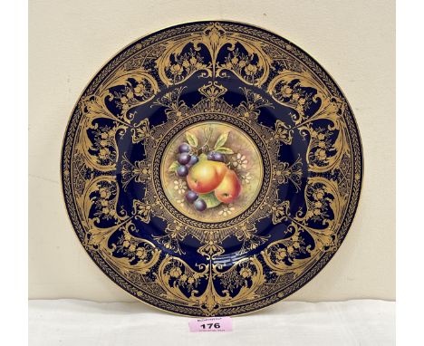 A Royal Worcester plate painted to the centre with fruit signed Leaman, within a richly gilded blue ground border 10½" diam.