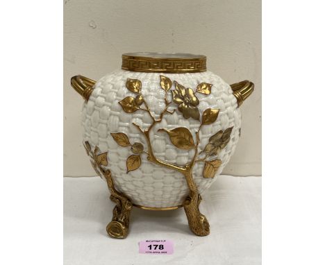 A Royal Worcester two handled ovoid basket weave vase, gilded with prunus, raised on naturalistic feet. 8" high