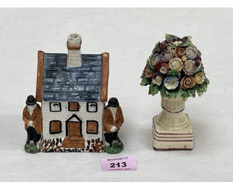 A Staffordshire cottage money box, 4½" high and a Staffordshire model of a flower filled vase.
