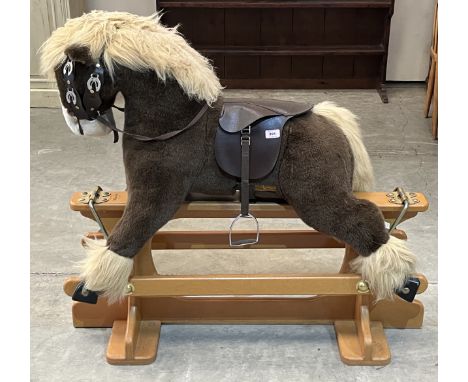 A Merrythought rocking horse on trestle stand. The stand 40" long