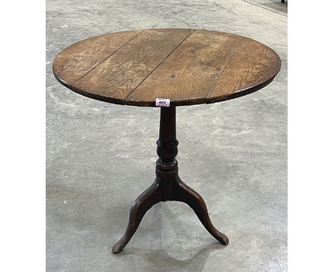 A 19th century oak pillar table with snap-top, on tripod support. 29" diam.