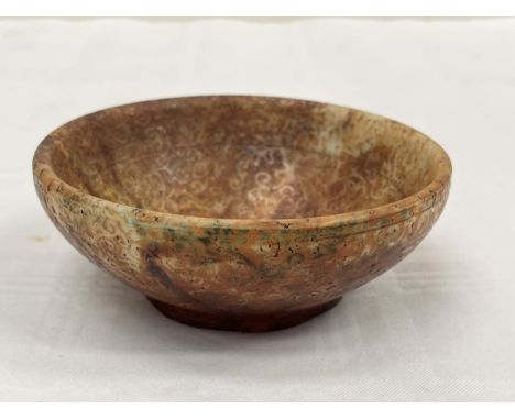 A Chinese russet jade bowl carved with scrolling tendrils. Possibly Qianlong period. 4¼" diam.