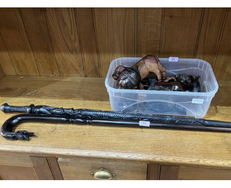 A collection of treen to include a lignum vitae walking stick; a pair of African carved lignum heads, a bear etc.