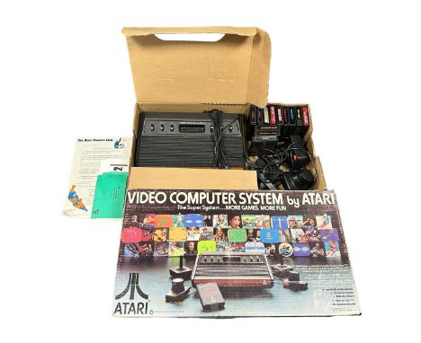 Atari CX-2600 console in good original box, with paperwork, 2x joystick, 2x paddle controllers, 1x power source. Also include