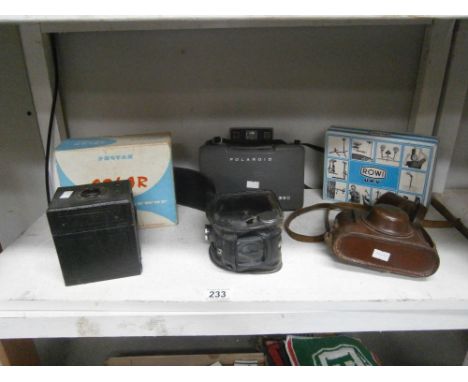 A collection of vintage cameras including Solar and Polaroid