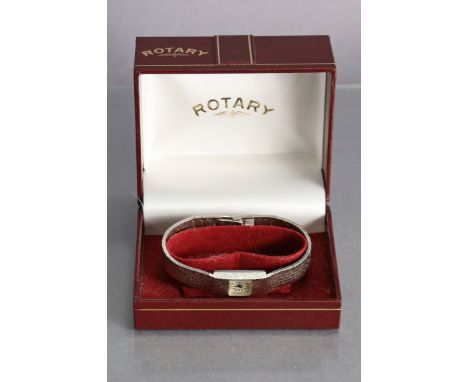 A Bulova stainless steel ladies’ bracelet watch with baton numerals to the silvered cushion-shaped dial; &amp; a Rotary stain