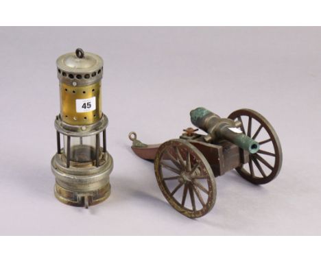 A brass &amp; steel miner’s lamp, 9¾” high; &amp; a model cannon, 10” long