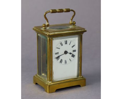 A French brass-cased carriage clock with black roman numerals to the white enamel dial, 4¼” high.