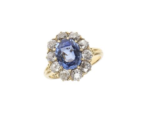 the oval-shaped sapphire weighs approximately 4.40 carats and is set within a surround of ten cushion-shaped old-cut diamonds