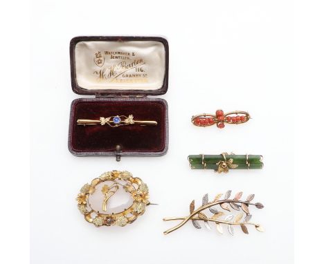 including a jade and 9ct gold brooch, 5cm long, a coral and 9ct gold brooch, 4cm long, a chalcedony and gilt metal foliate br