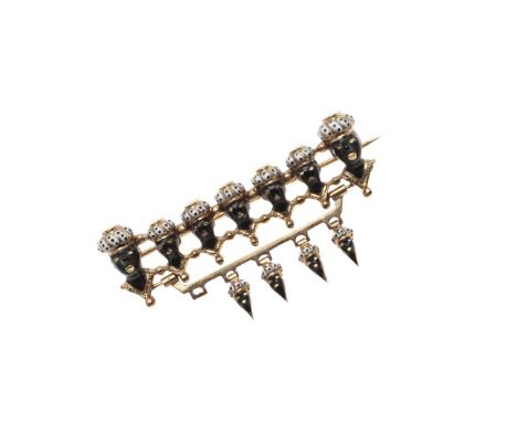 decorated with black and white enamel, set in gold, 4.5cm long, 7.4 grams. *Condition: One drop is missing, some wear.