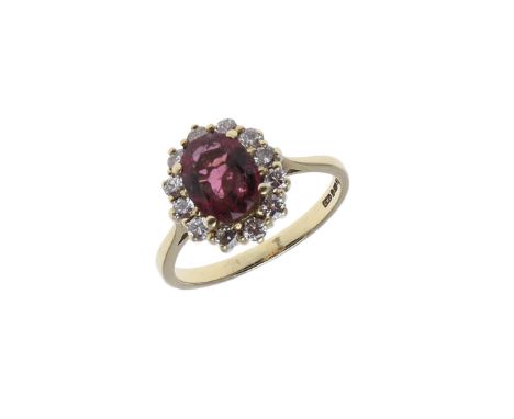 the oval-shaped pink tourmaline is set within a surround of circular-cut diamonds in 18ct yellow gold, 5.1 grams. Size R. *Co