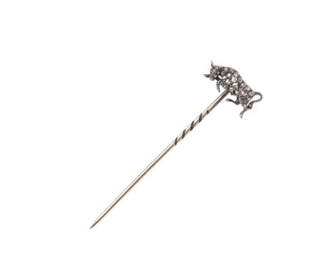 in the form of a charging bull, set with rose-cut diamonds, with cabochon ruby eye, in silver and gold, 2.3 grams. *Condition