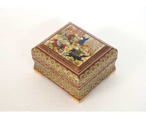 EASTERN INLAID WOODEN TRINKET BOX
the hinged lid with raised handpainted figures on horseback, raised on shaped footed base, 