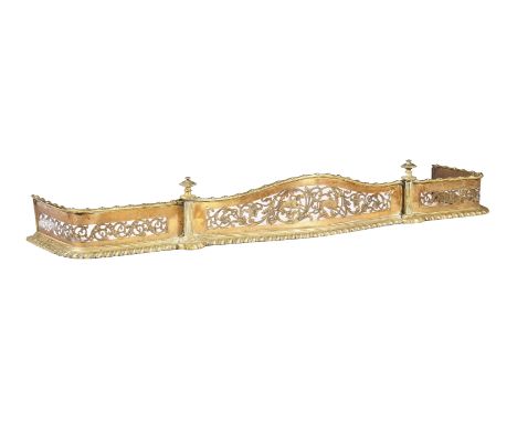A GEORGE III GILT BRASS FIRE FENDERPOSSIBLY IRISH, CIRCA 1800Of serpentine outline, with pierced stag hunting scene and folia