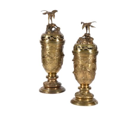 A PAIR OF JAPANESE POLISHED BRONZE INCENSE BURNERS 19TH CENTURY The terminals with eagles above a rocky outcrop and coiled se