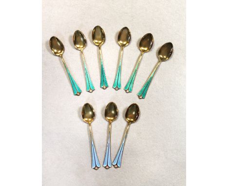 each with green guilloche enamel decoration; together with three similar blue enamel spoons (9)