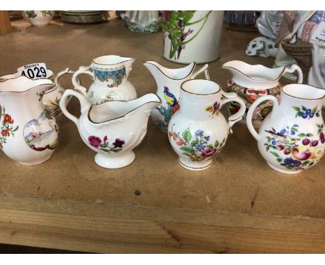 A collection of Royal Worcester jugs decorated with various period patterns.  NO RESERVE