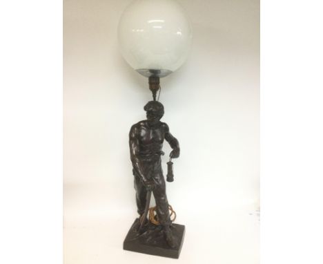 A French spelter figural lamp depicting a miner, approx total height 90cm. Shipping category D.