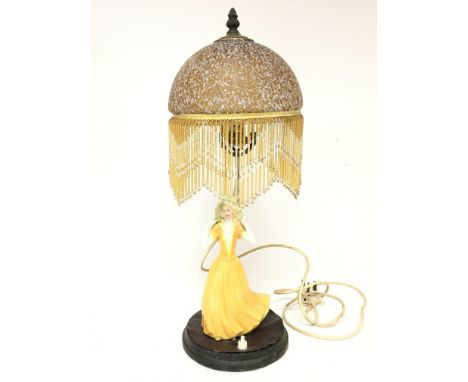 An Art Deco side lamp surmounted with a porcelain figure of a lady , postage category D