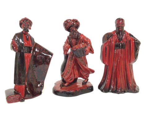 A collection of Royal Doulton Flambe figurines including The Carpet Seller HN 2776, The Lamp Seller HN 3278, Confucius HN 331