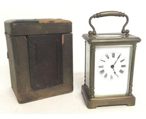 A cased French 8 Day Brass Carriage clock, with turned side pillars and bevel glass encasing. Circa 1860. With key . Postage 