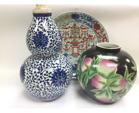 Three Chinese porcelain items comprising a blue and white double gourd vase converted in to a lamp, a dish decorated with fig