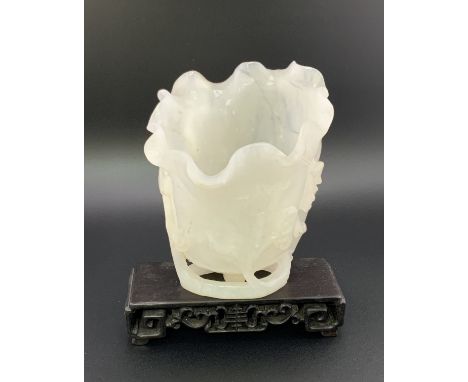 A Chinese carved white jade vase In furled lotus leaf form with ruyi and vine decoration, 10cm together with a finely carved 