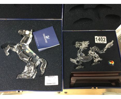 Two Swarovski figures including rearing horse and Chinese dragon on stand with pearl. Both in fitted boxes. No obvious damage