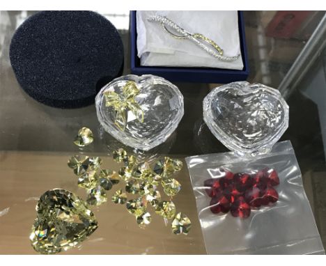 Two Swarovski heart shaped trinket boxes, together with loose hearts in yellow and red. Also a boxed Swarovski bar brooch and
