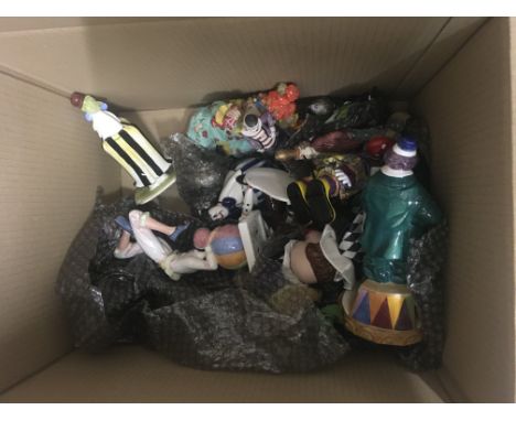 A box of ceramic clown figures and clown toys.