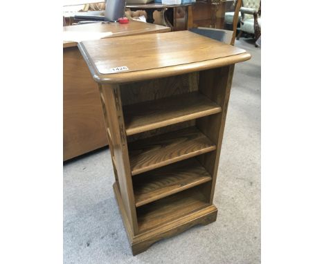 An Ercol open display and CD stand with open shelves to the front and side shelfs.  NO RESERVE