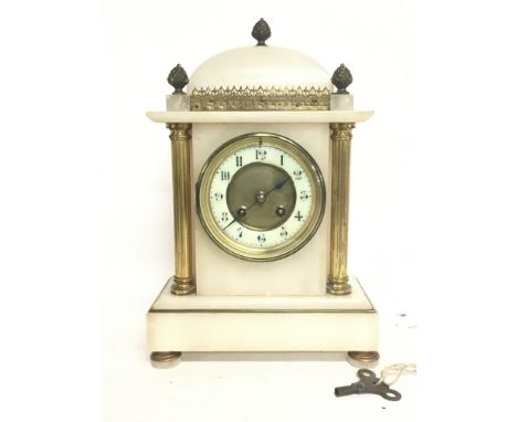 A French Onyx clock decorated with pillars, acorns and a bronzed dial. 34cm tall with key. Postage category D