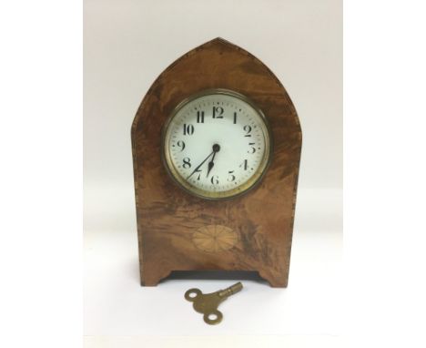 A small inlaid walnut arch topped clock, approx height 23cm. Comes supplied with a key. Shipping category D.  NO RESERVE