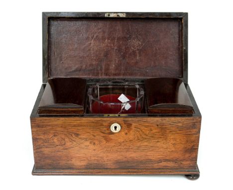 A late Georgian rosewood tea caddy, with original mixing glass and tea boxes, complete with key, raised on squat ball feet