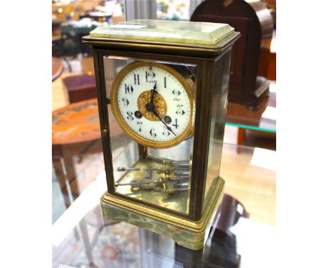 A brass and onyx eight day mantle clock, with a white enamelled chapter dial, having a spring driven movement