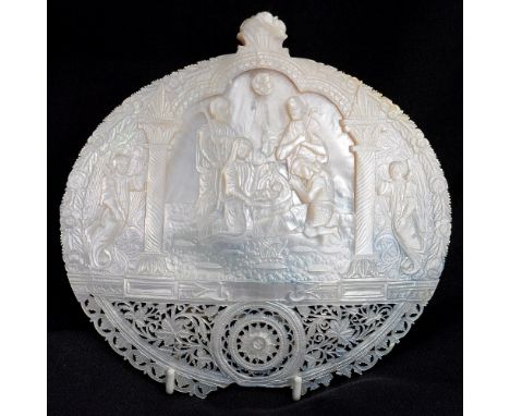 A large carved mother of pearl shell, depicting the birth of Christ
