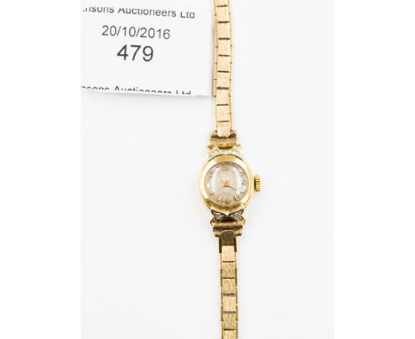 A vintage ladies 18ct gold cased wristwatch on a 9ct gold braclet, fine case diamond chip set to lug covers, total gross gold