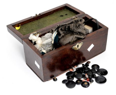 A mahogany Georgian tea caddy with brass handle and lock, containing sewing aids and buttons and a collection of jet buttons 