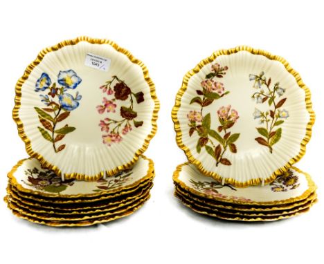 A set of twelve Royal Worcester ivory ground dessert plates, circa 1888, wavy gilt edge with moulded wavy design, printed and