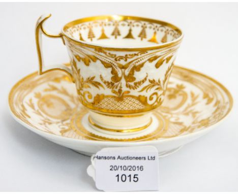 A Spode relief moulded cup and saucer, circa 1820, gilt foliate scroll decoration, painted mark and number 3782 (2)