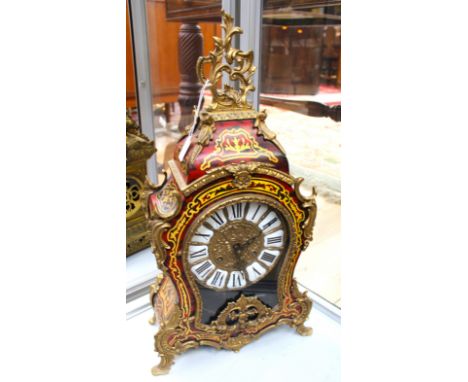 A French style mantel clock, stylised brass decoration, Roman numerals, glazed, lacquered case 