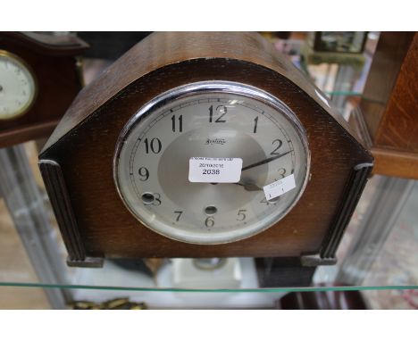 An Art Deco wood veneered mantle clock 