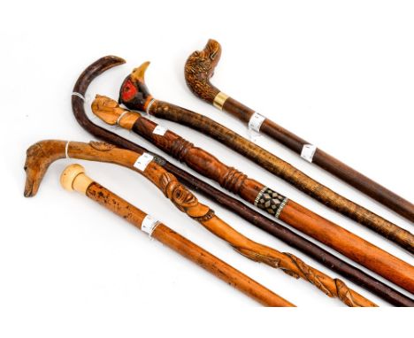 A collection of six assorted walking sticks, late 19th and 20th Century, including a malacca stick with ivory pommel, a hazel