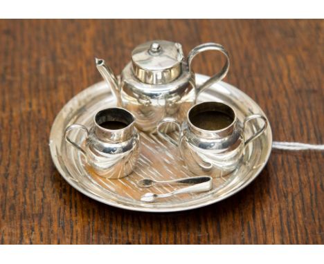 A miniature four piece Chester 1905 silver tea service with miniature tongs (5) 0.915 ozt/ 28.5 grams gross approx 