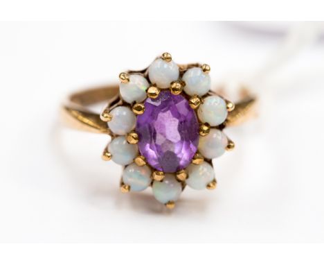 An amethyst and opal cluster 9ct. gold dress ring size Q, weighing approx 4.2 grms