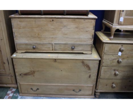 A late 19th Century pine trunk, having two short drawers, together with a 20th Century pine trunk with a single drawer, (2)
